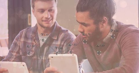 Two men collaborating using tablets in relaxed cafe workspace