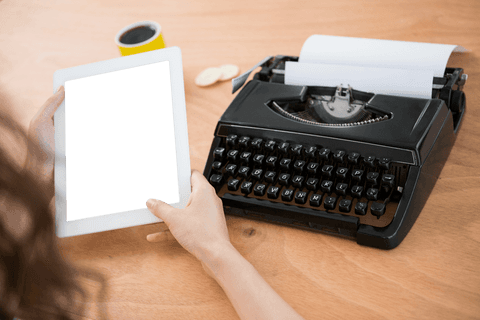 person holding tablet near vintage typewriter on wooden desk - Download Free Stock Videos Pikwizard.com