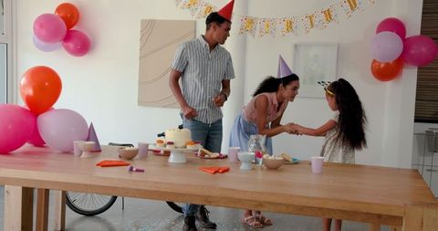 Family Celebrating Birthday at Home with Decorations and Cake