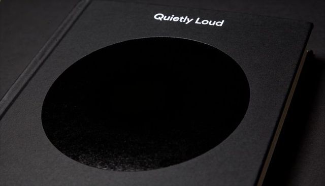 Minimalist black hardcover with glossy circular spot varnish and quietly loud cover title