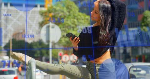 Balancing woman stretching leg on railing with smartphone in busy urban street traffic