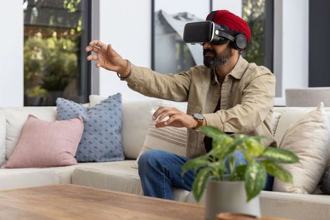 Man Experiencing Virtual Reality in Modern Living Room Setting