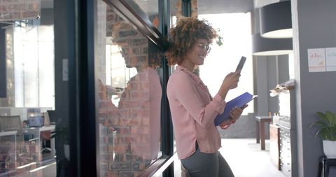 Confident Businesswoman Engaged in Smartphone Communication
