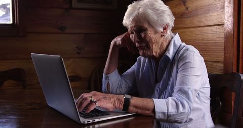 Senior Woman Using Laptop in Wooden Home Interior - Download Free Stock Images Pikwizard.com