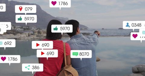 Couple on coastal outing pointing at tidal pool with social media notifications overlay