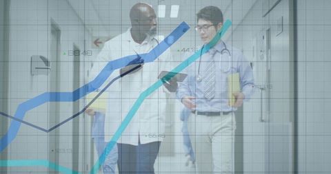 Doctors Analyzing Data on Hospital Corridor