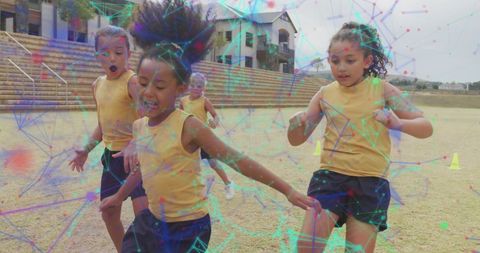 Energetic Schoolgirls Playing Soccer Amid Digital Overlay