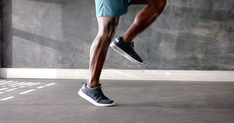 Athlete performing leg exercise at modern gym