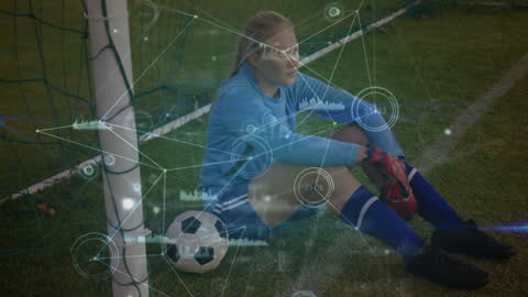 Young Soccer Player Analyzing Data in Goal