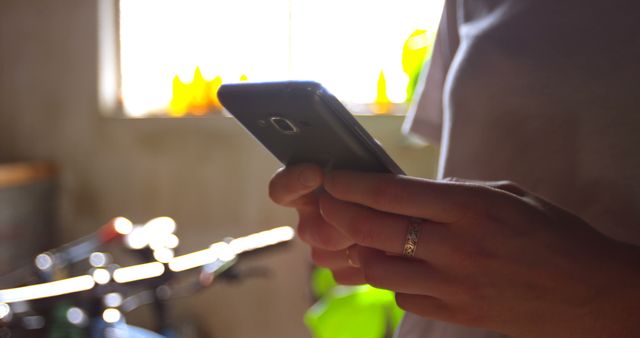 Person Using Smartphone Indoor with Sunlight from Window - Download Free Stock Images Pikwizard.com