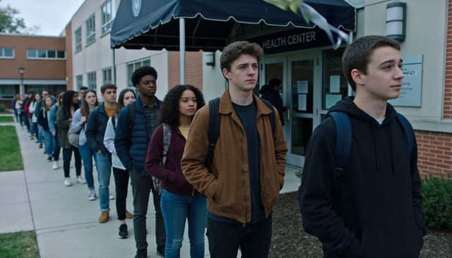 College students standing in line outside health center waiting for campus services