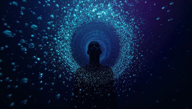 Floating Male Silhouette Drifting Through Luminous Bubble Vortex in Deep Blue