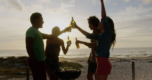 Friends Cheerfully Toasting Beers at Beach Barbecue During Sunset - Download Free Stock Images Pikwizard.com