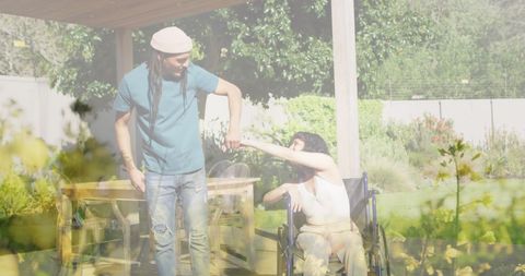 Care and friendship outdoors with wheelchair user