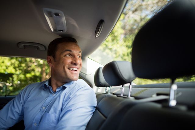 Cheerful man looking through windshield