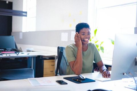 Professional Engaging in Video Call While Remote Working at Modern Office
