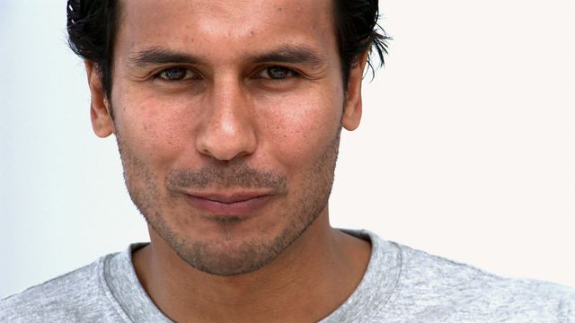 Man appears content while eating. White background makes suited for promotional materials, food advertisements, or health campaigns. Neutral setting highlights human expression effictively across diverse inclusions.