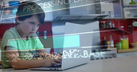 Schoolboy using laptop at kitchen counter with futuristic processing data overlay
