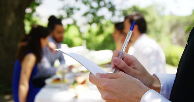 Waiter taking order from group seated outdoors - Download Free Stock Images Pikwizard.com