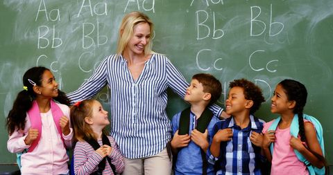 Smiling Teacher Engaging with Class of Diverse Young Students - Download Free Stock Images Pikwizard.com