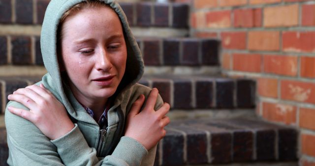 Sad Young Woman Sitting on Stairs in Casual Hoodie - Download Free Stock Images Pikwizard.com