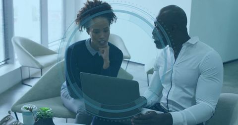 Two Professionals Collaborating in Stylish Office Lounge Area