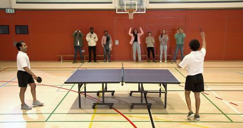 Vibrant Table Tennis Match in School Gymnasium