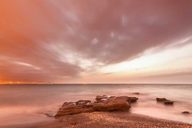 Long Exposure of Tranquil Beach and Rock Formation at Sunset - Download Free Stock Photos Pikwizard.com