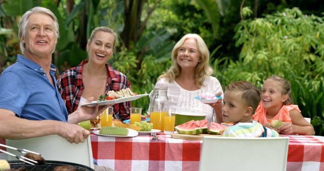 Multi-Generational Family Enjoying Picnic In Garden - Download Free Stock Images Pikwizard.com