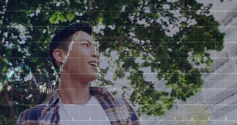 Young man in plaid looking up with financial chart overlay, urban trees and glass facade