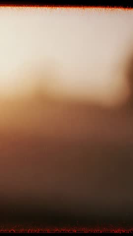 Vertical ambient video showing blurred beige gradient with flickering red bars top and bottom