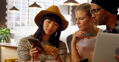 Young Diverse Adults Working Collaboratively with Smartphone