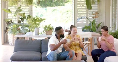 Friends Chatting over Coffee in Bright Living Room