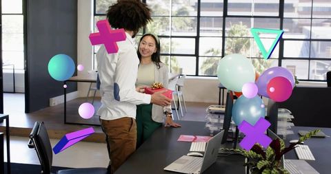 Colleagues exchanging gift in modern office celebrating with balloons and ar overlays