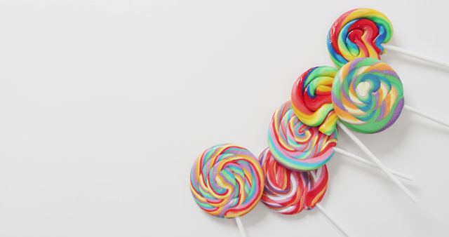 Vibrant Array of Multi-colored Swirled Lollipops on White Background - Download Free Stock Images Pikwizard.com