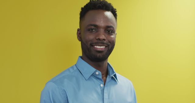 Smiling Businessman Against Yellow Background in Blue Shirt - Download Free Stock Images Pikwizard.com