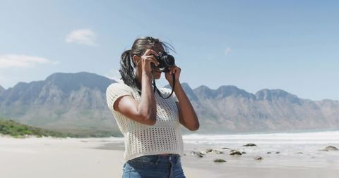 Female Photographer Captures Scenic Mountain Beach Landscape