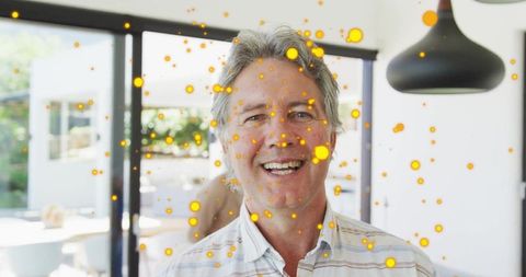 Happy Man Enjoys Vibrant Atmosphere with Abstract Yellow Dots