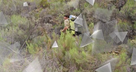 Trekking hiker navigating rocky hillside with wilderness gear