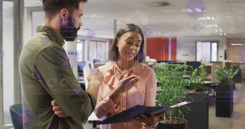 Colleagues engaged in professional discussion in modern office