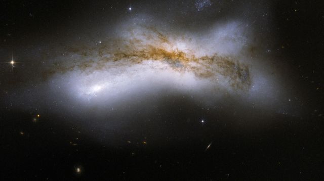 NGC 520 is the product of a collision between two disk galaxies that started 300 million years ago. This image is part of a large collection of images of merging galaxies taken by NASA Hubble Space Telescope.