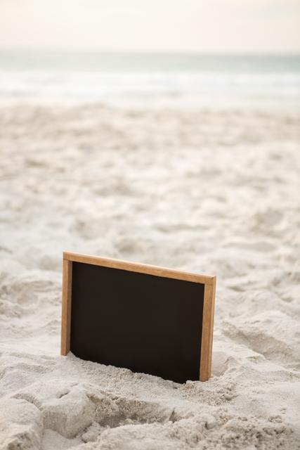 Blank slate in sand at beach