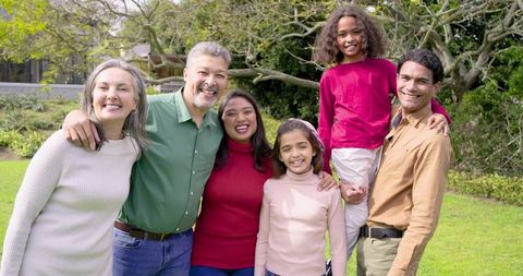 Multigenerational family smiling in garden celebrating togetherness and outdoor joy
