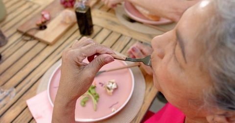 Senior Woman Enjoying Meal with Friends at Outdoor Dinner - Download Free Stock Images Pikwizard.com