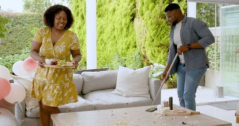 Couple Collaboratively Hosting Outdoor Patio Party with Snacks