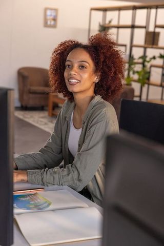 Professional Woman Enthusiastically Engaged in Office Work