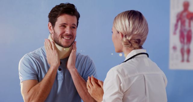 A doctor is attending to a patient who is wearing a neck brace, indicating a neck injury. The patient appears to be explaining his symptoms or condition to the doctor in a clinical environment. This image can be used in contexts related to healthcare, medical consultations, recovery from injuries, medical support, and doctor-patient interactions.