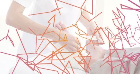 Caregiver applying abdominal bandage to reclining patient in clinic with abstract overlay