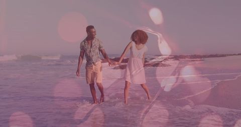 Romantic Couple Strolling Along Sunset Beach