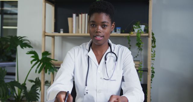 Confident Female Doctor in Office with Plants and Books - Download Free Stock Images Pikwizard.com